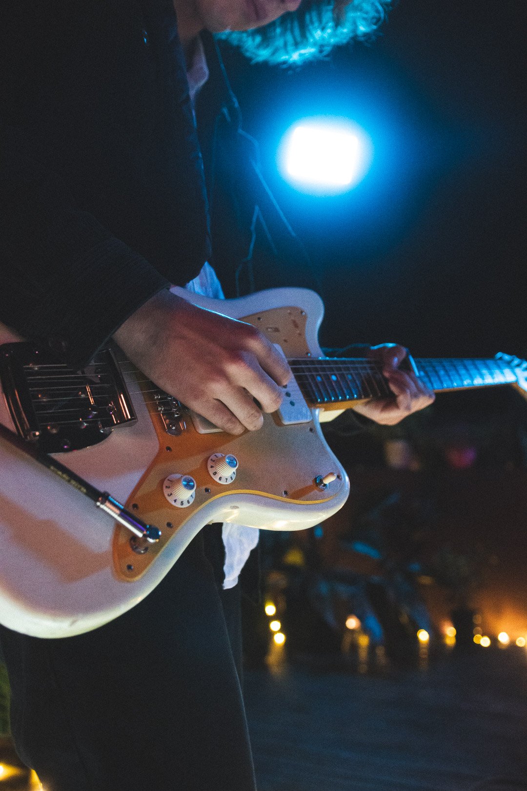 Close-up of EGOISM electric guitar being played during rooftop set.