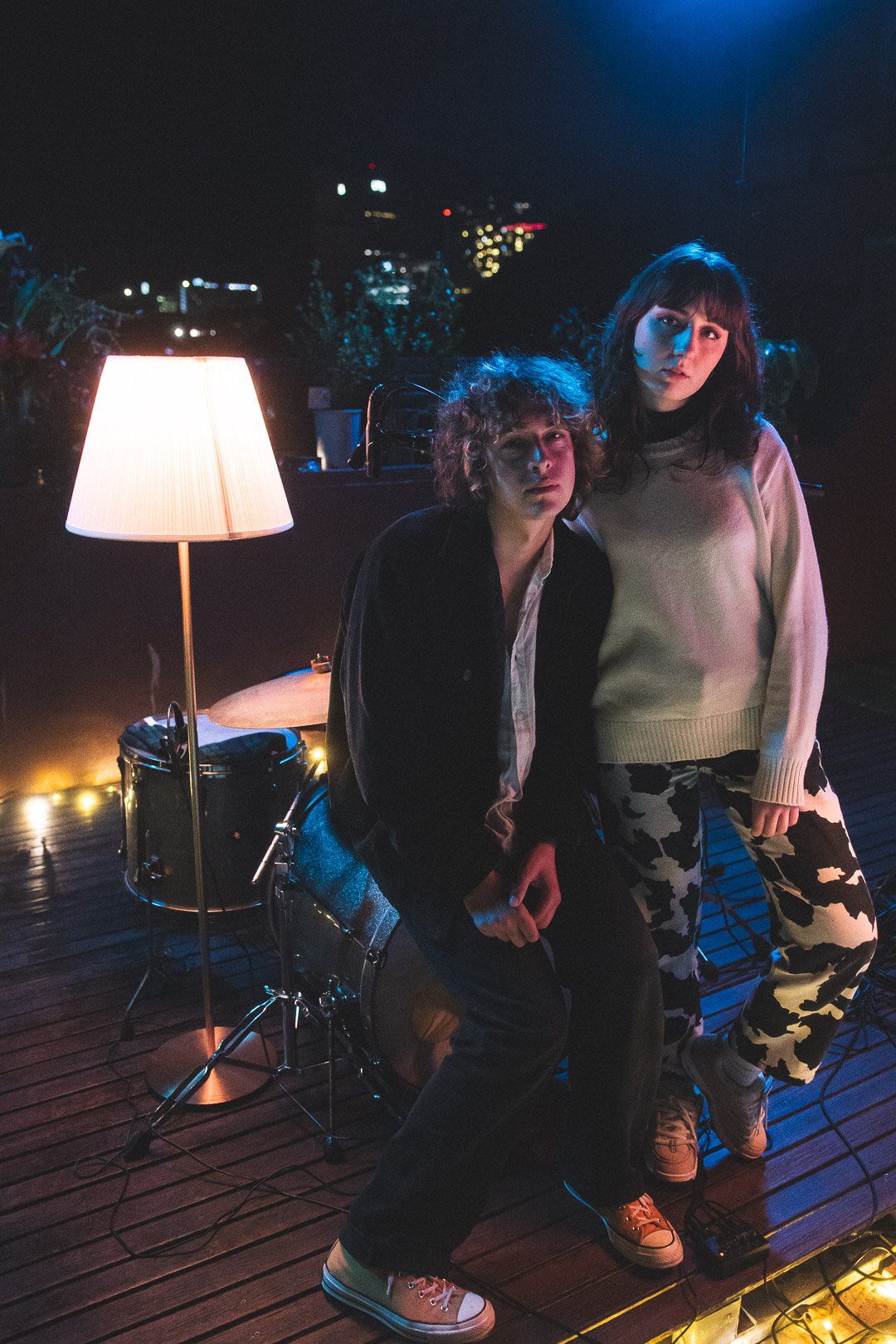 Scout Eastment and Olive Rush of EGOISM posing on the rooftop stage after their live performance.