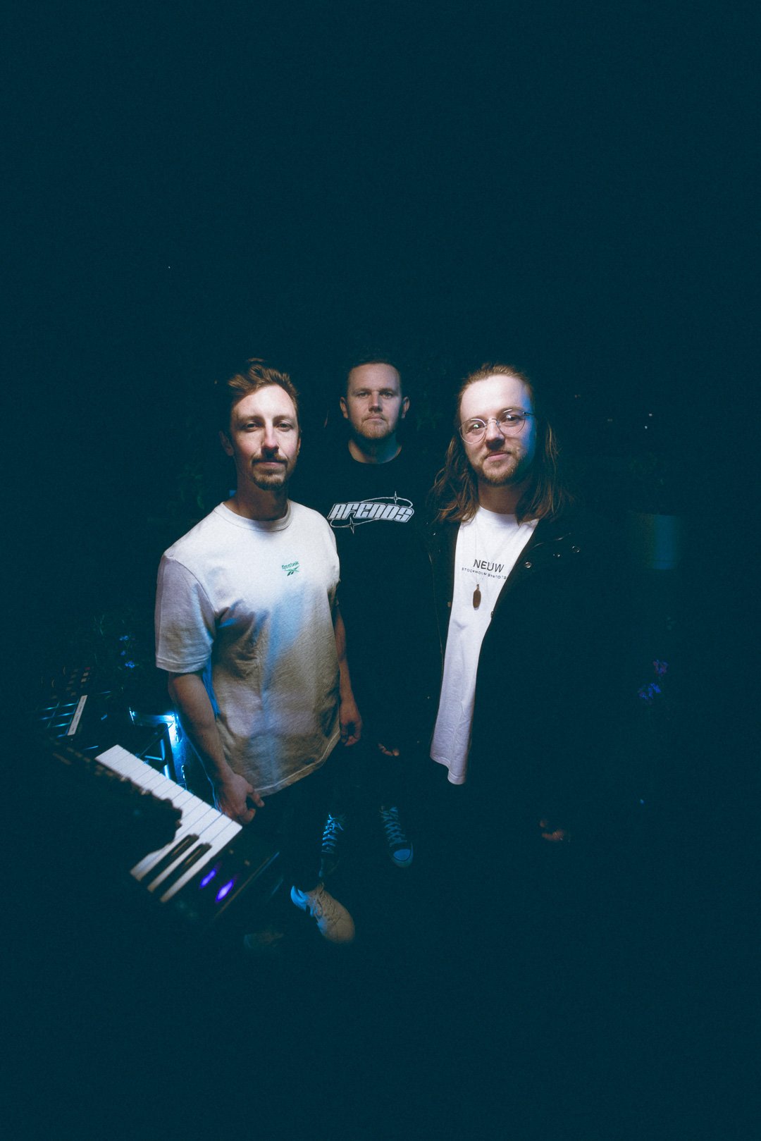 SAFIA band members standing together backstage on the rooftop.