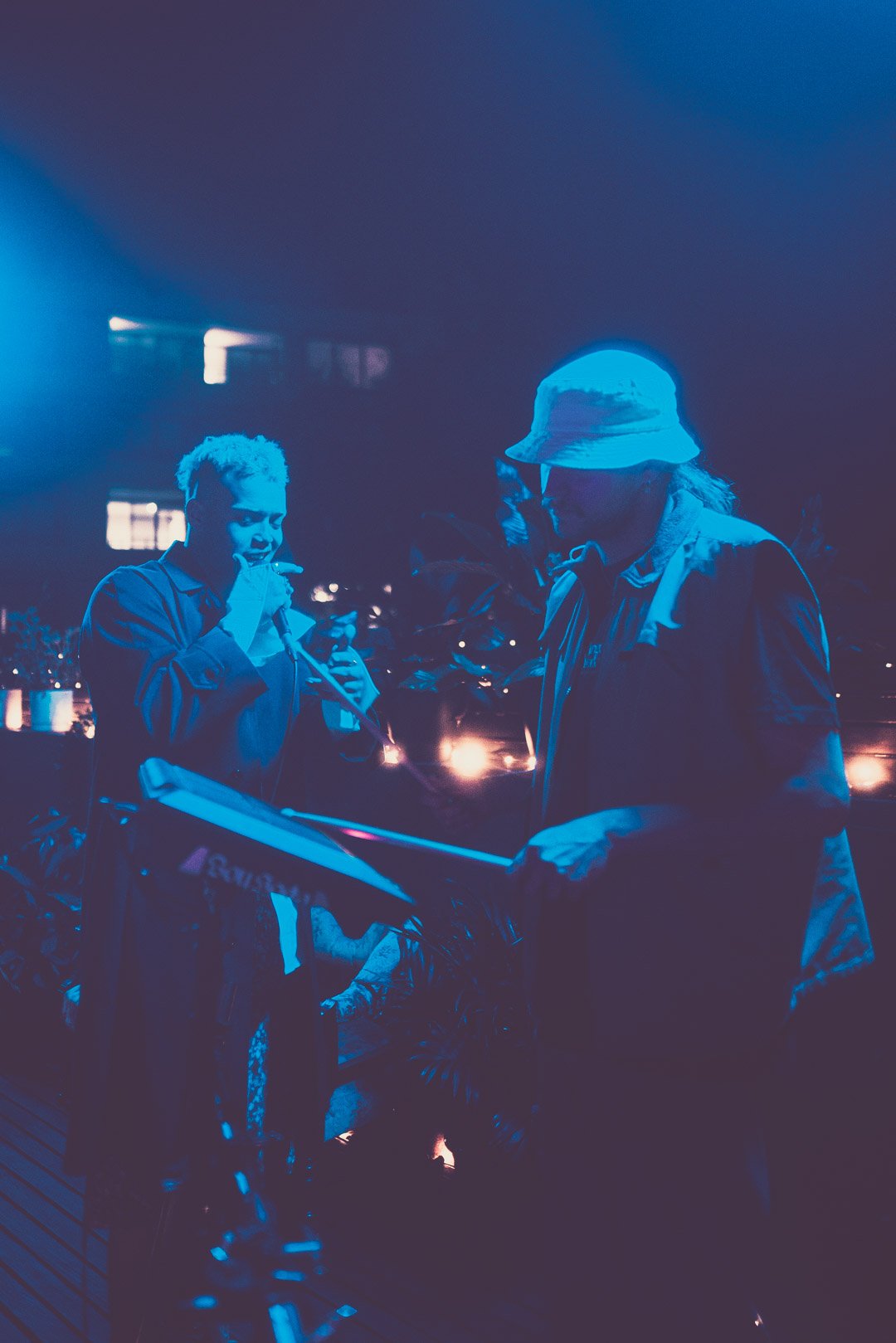 BOY SODA standing under stage lights between performance moments.