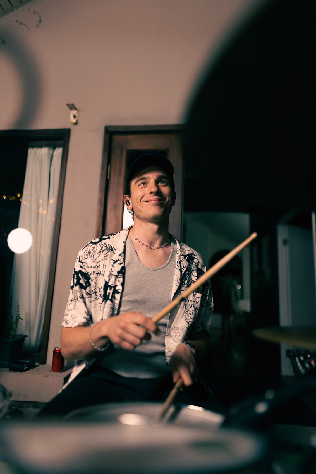 Drummer strikes snare and cymbals in sequence, wrists engaged, maintaining steady rhythm.