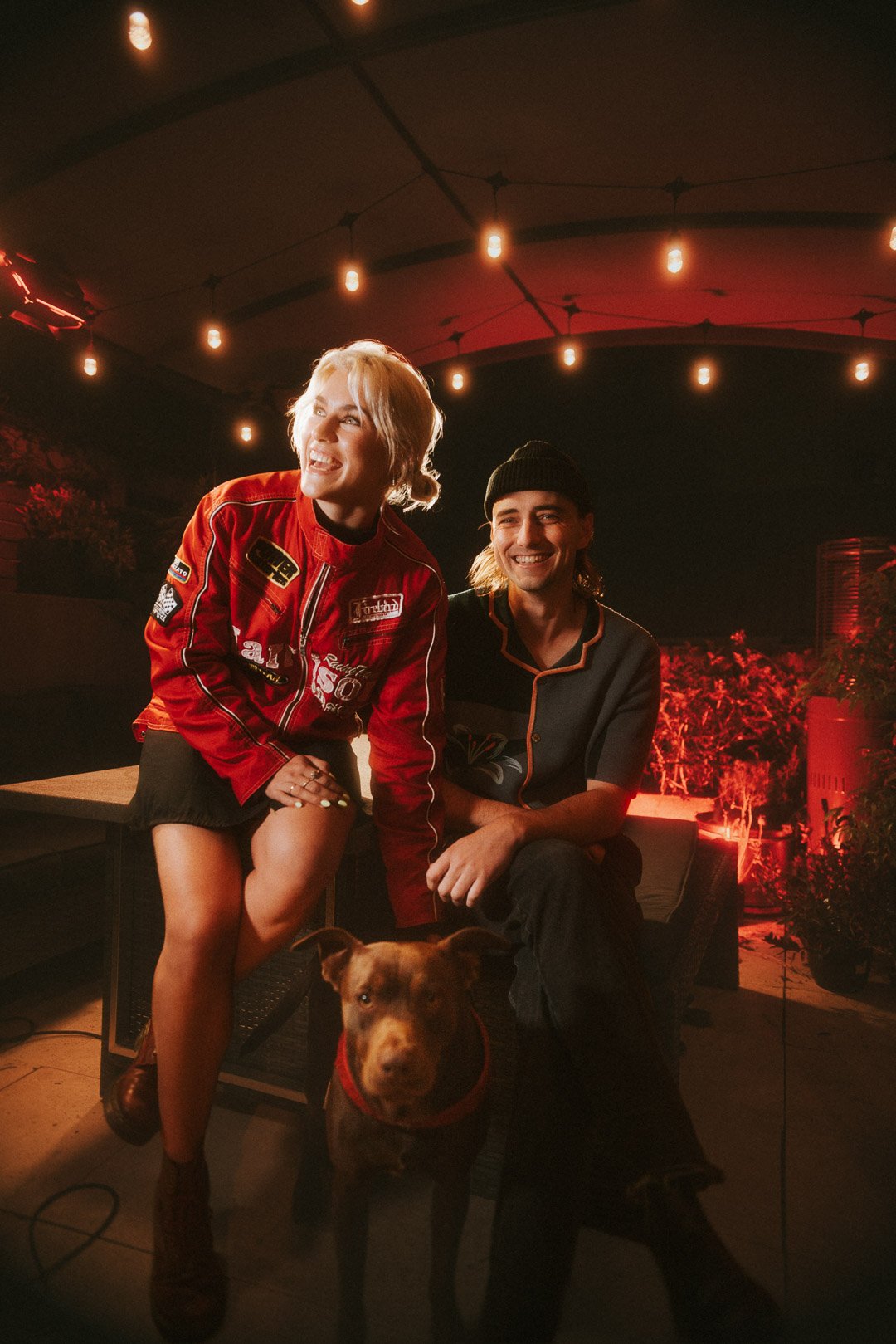 Foley laughing together on the rooftop with a dog during Mood on the Roof.