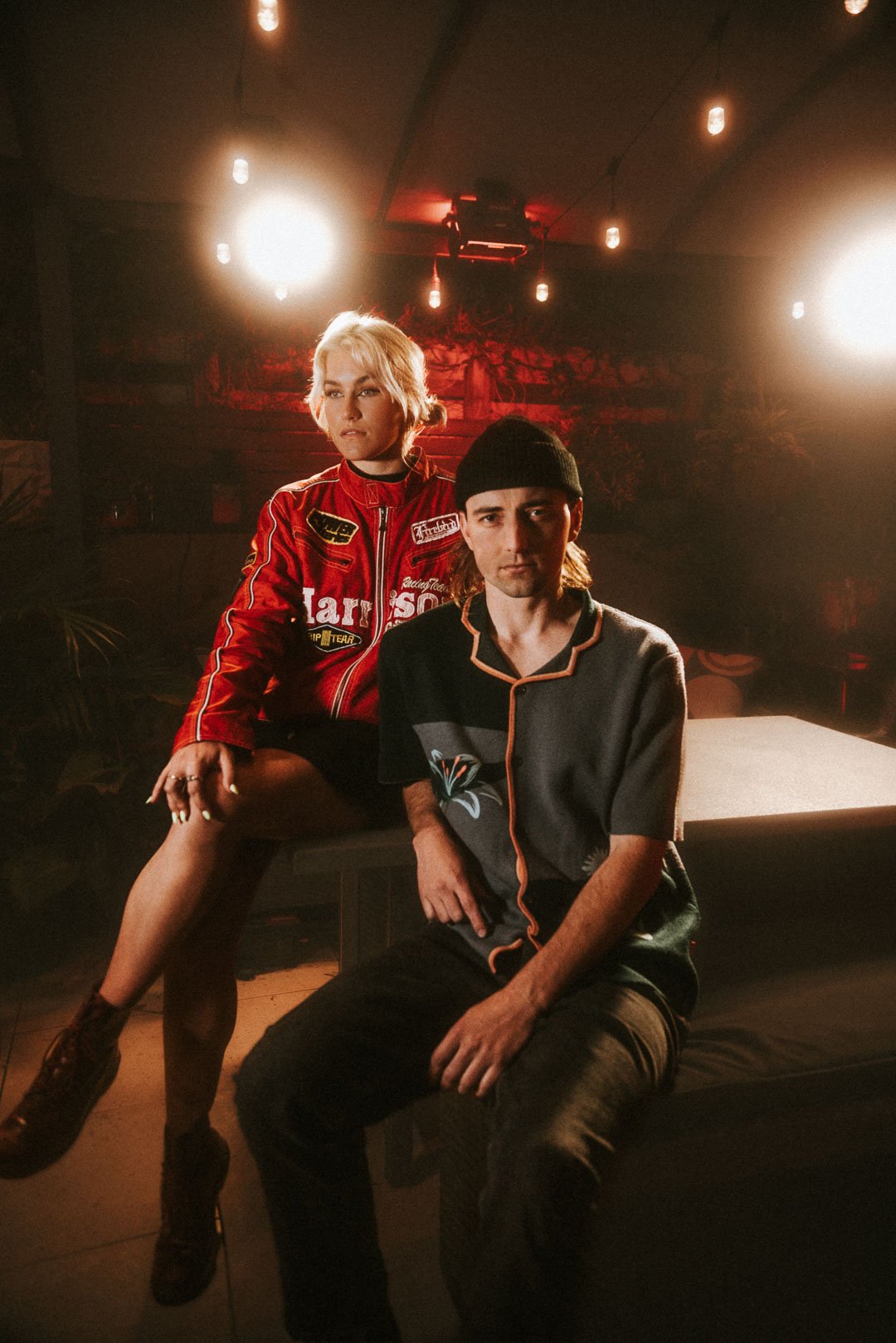 Foley seated on stage under warm lights during their Mood on the Roof session
