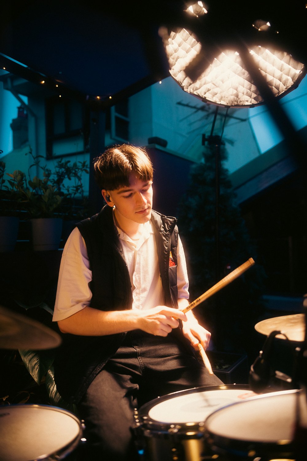 Session drummer focused on rhythm during RIIKI REID live rooftop set