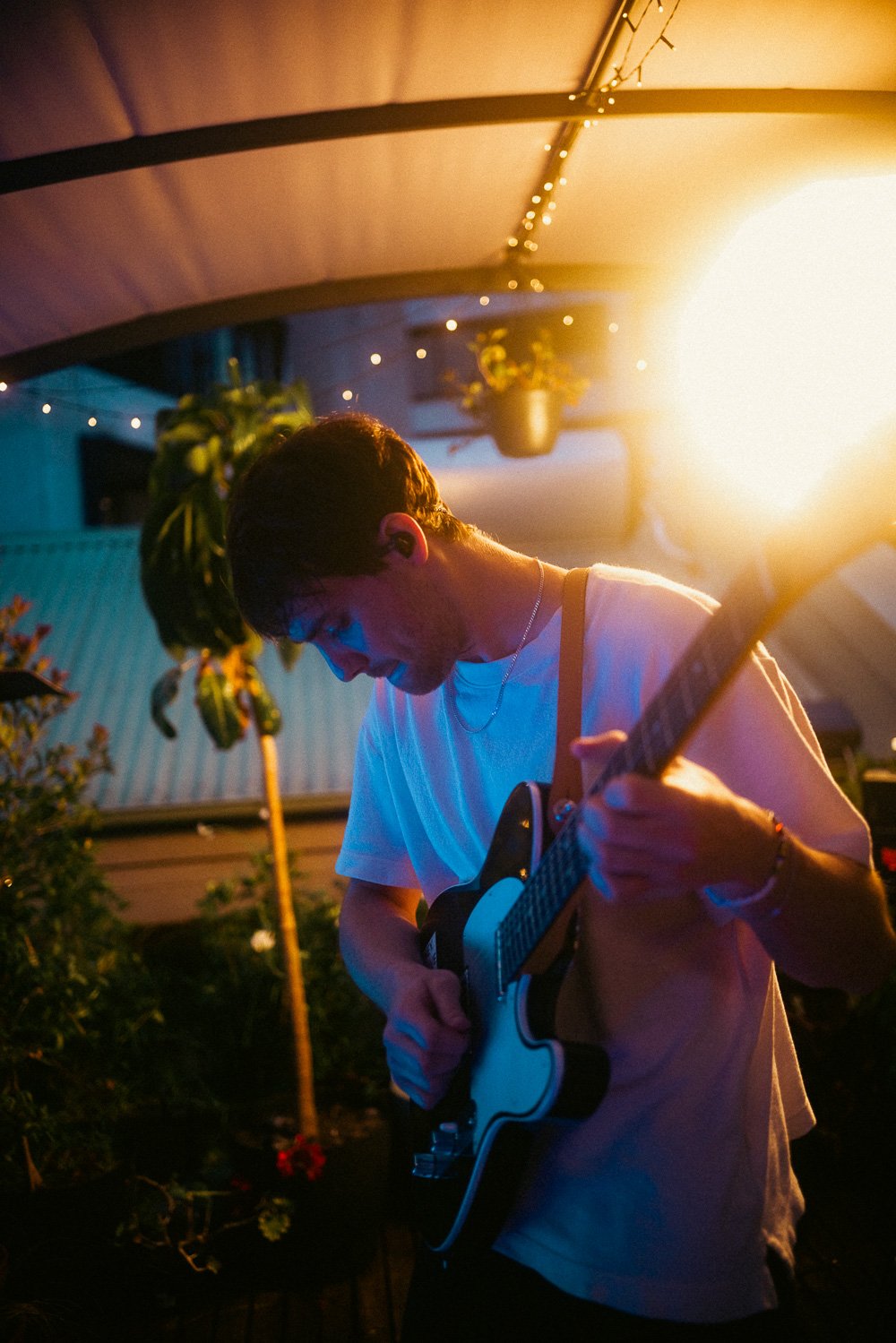 Session guitarist playing electric guitar during RIIKI REID rooftop performance