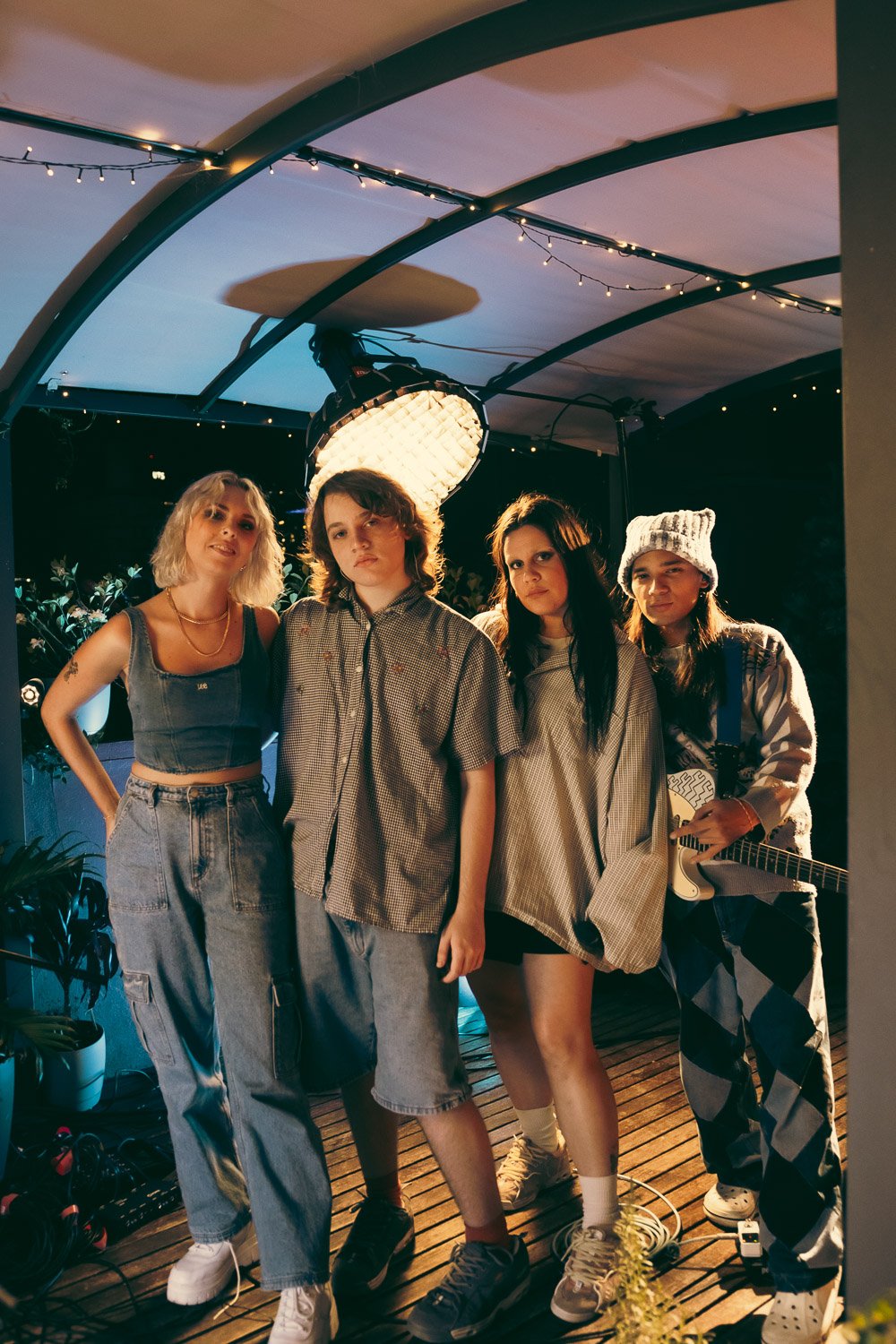 Caroline & Claude pose alongside their live band beneath the curved rooftop canopy.