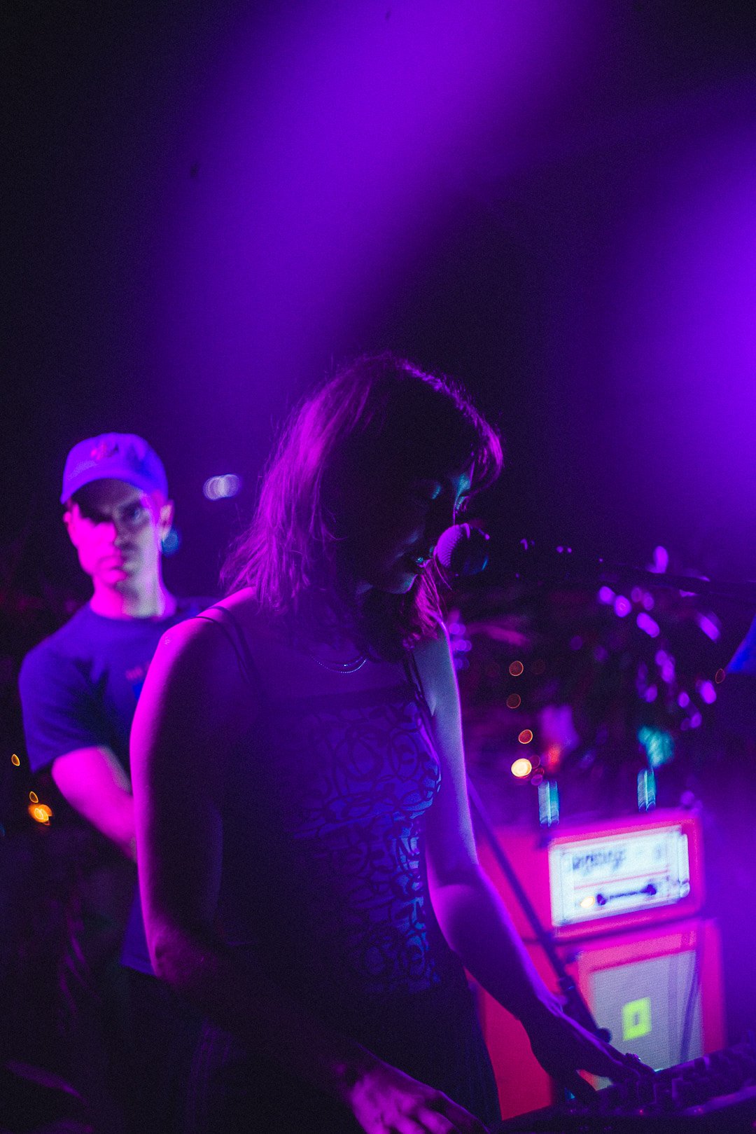 Band member playing keys under violet lights on Mood on the Roof.